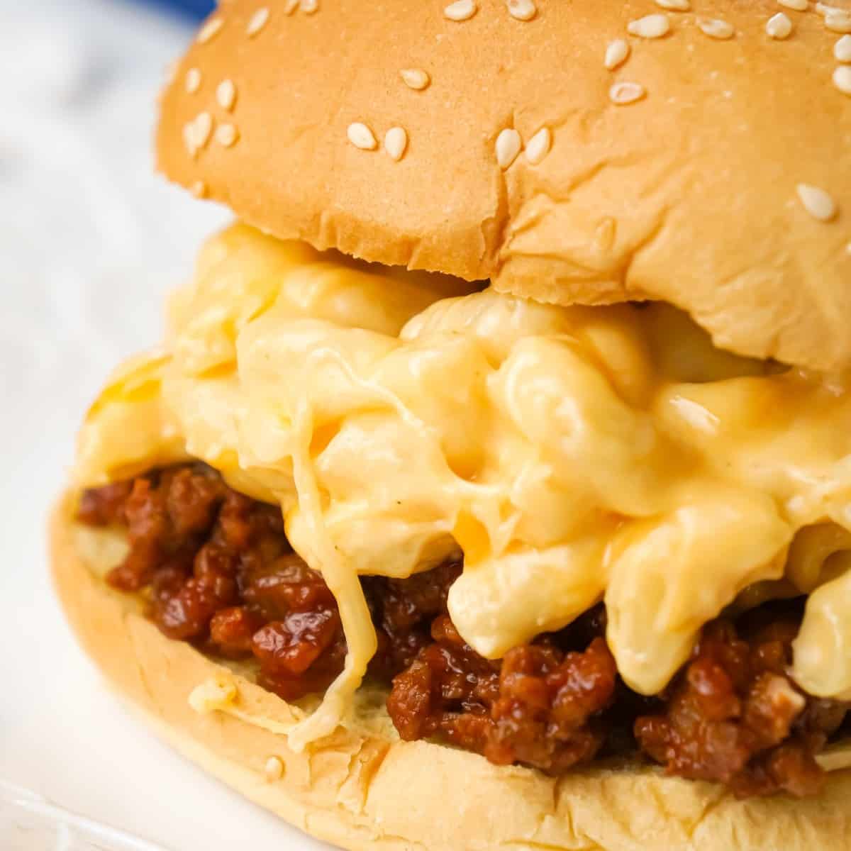 Mac and Cheese Sloppy Joes are hearty ground beef sandwiches topped with macaroni and cheese.