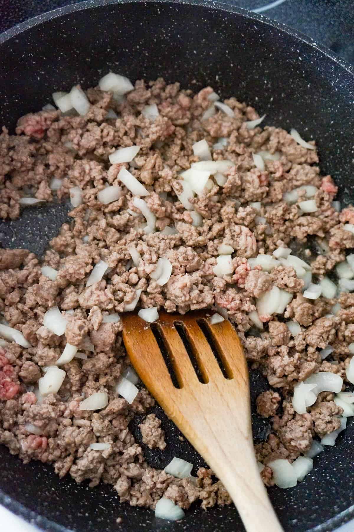 ground beef and diced onions in saute pan