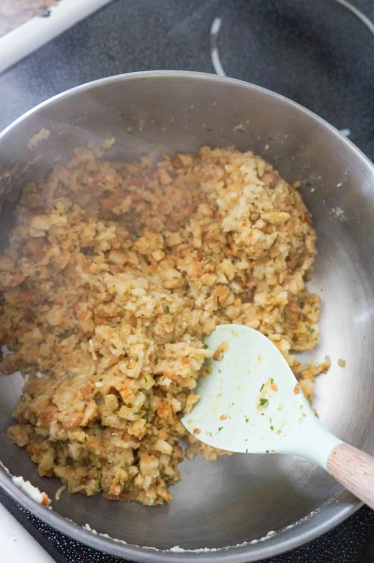 stove top stuffing being stirred in a large pot