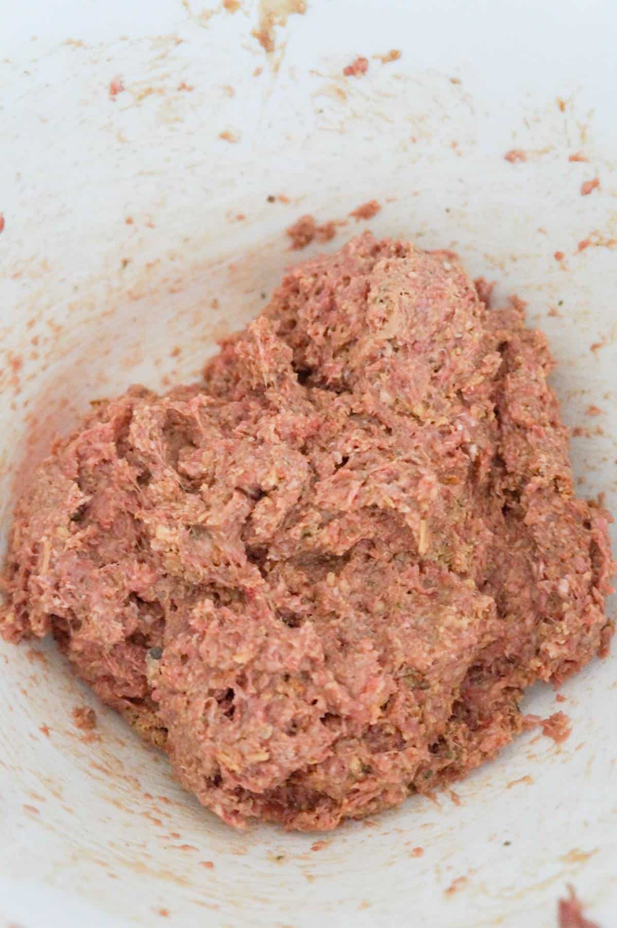 raw ground beef meatloaf mixture in a mixing bowl