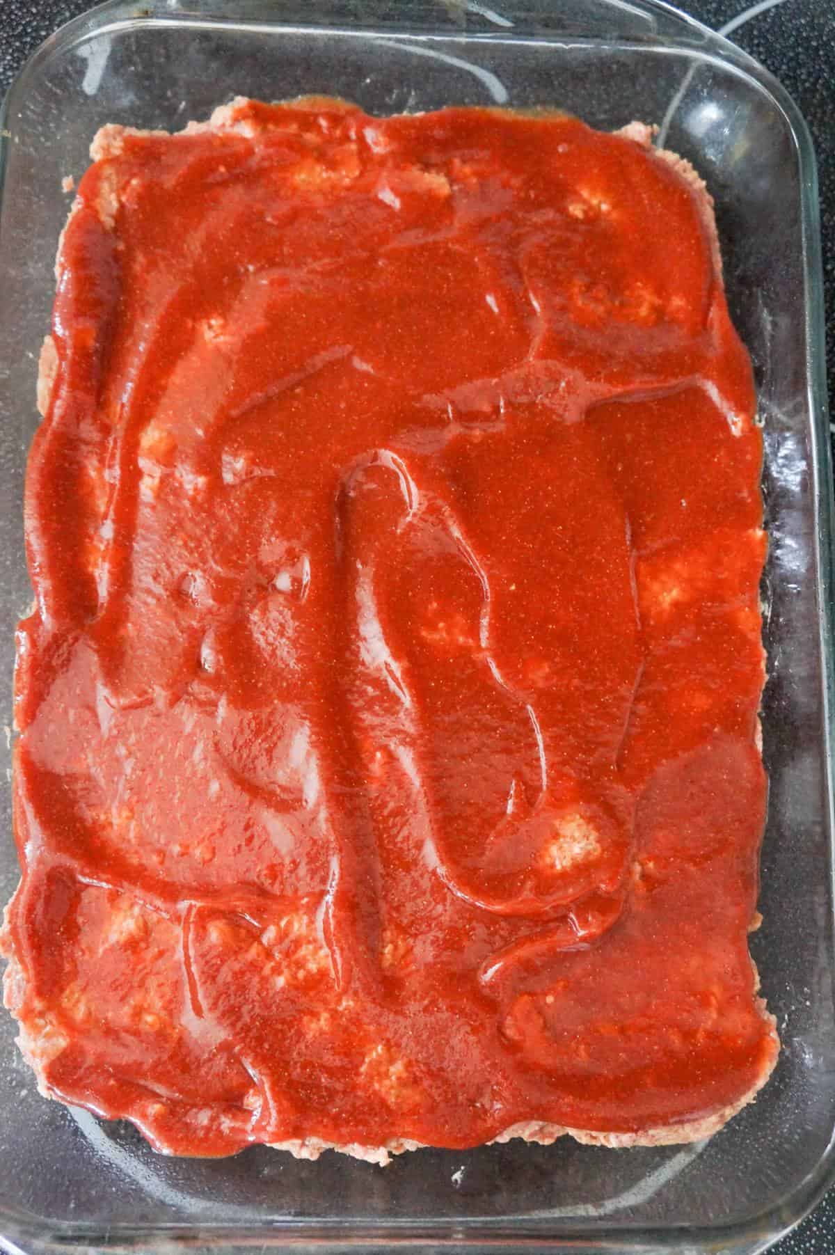 ketchup glaze on a meatloaf casserole in a baking dish