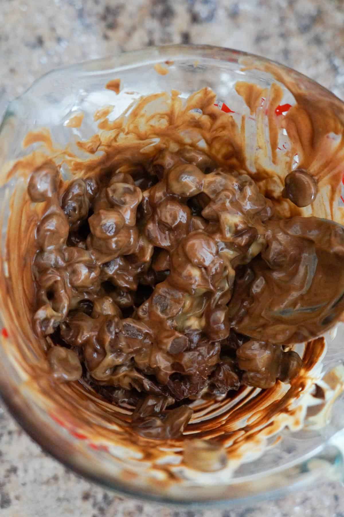 chocolate chips and peanut butter melted together in a glass measuring cup