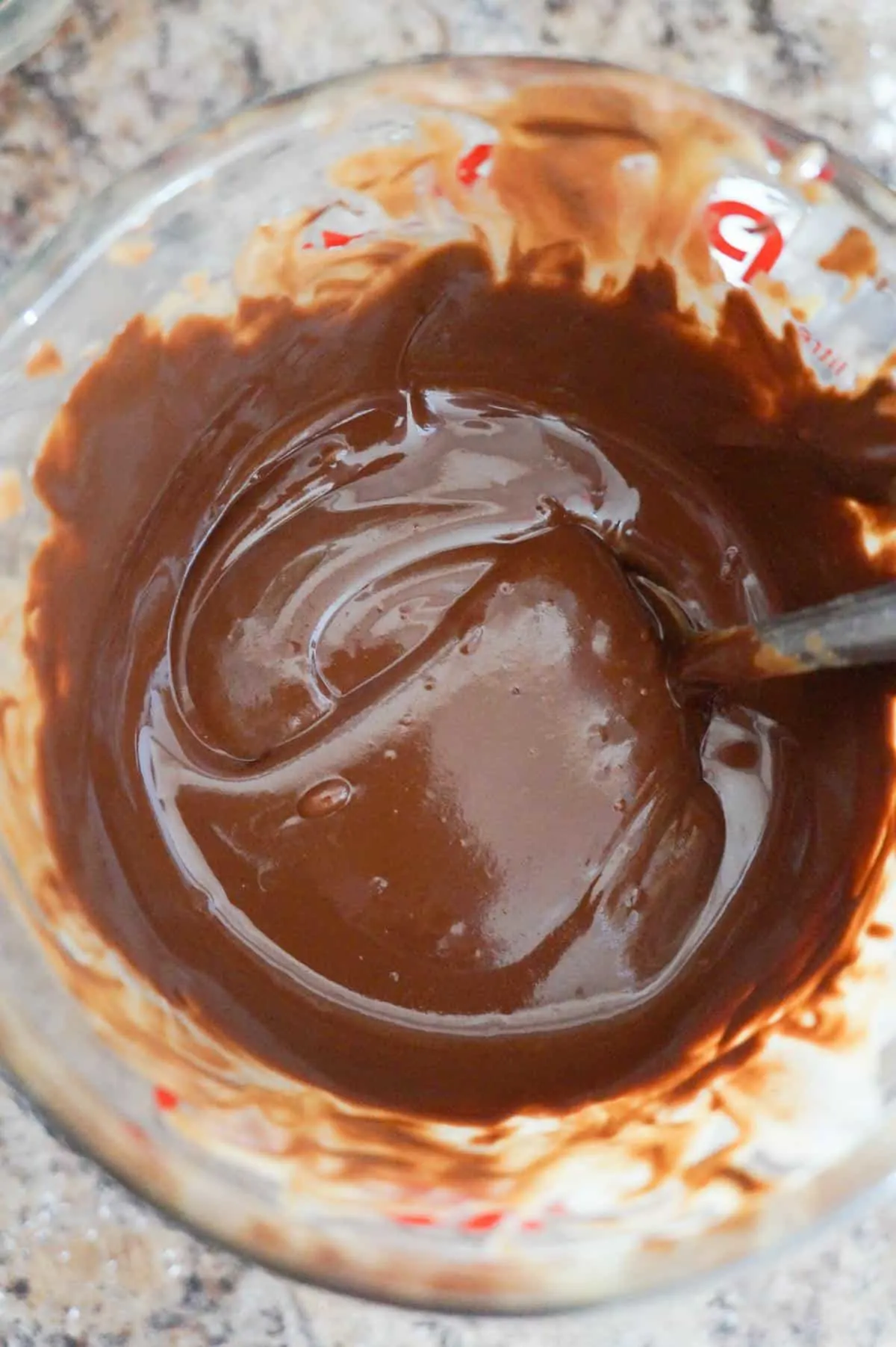 melted chocolate and peanut butter mixture in a glass measuring cup