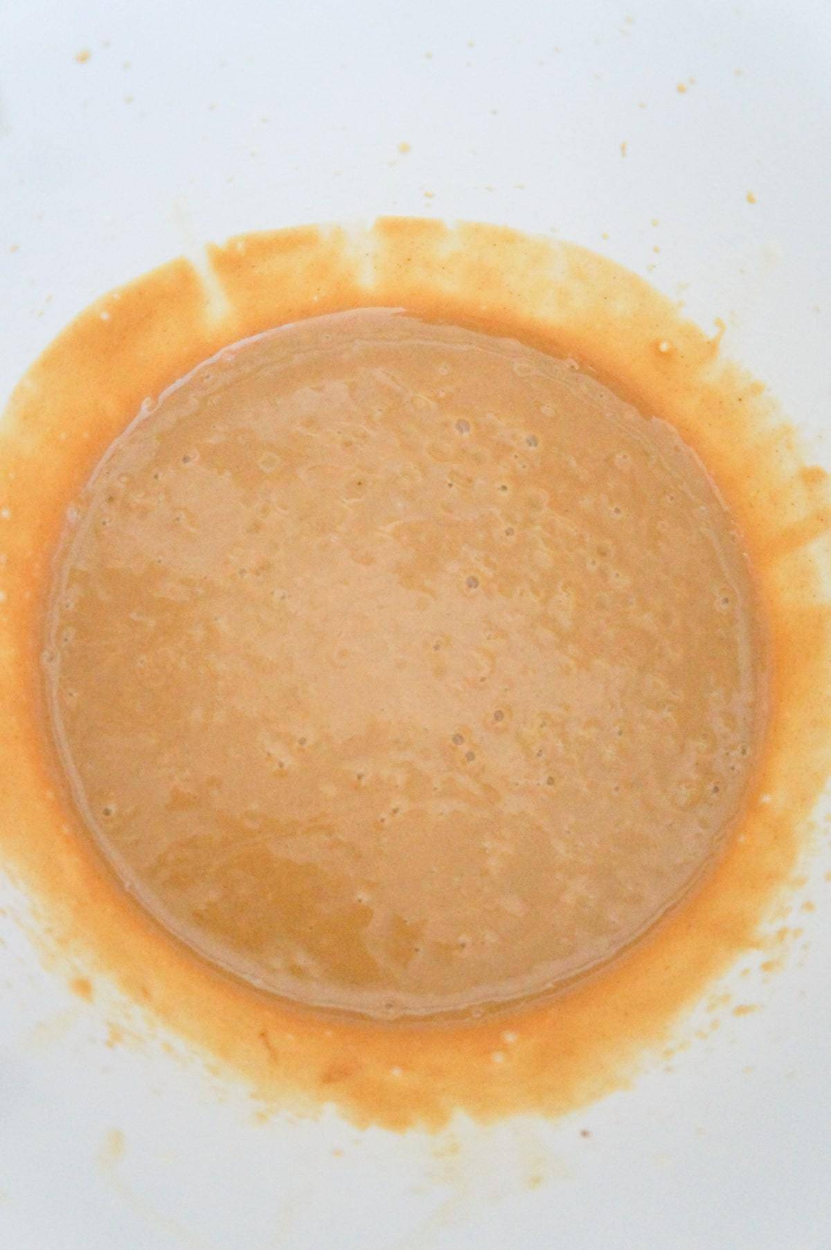melted butter and peanut butter combined in a mixing bowl