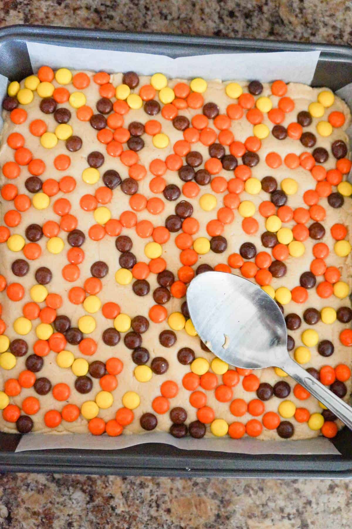 spoon on top of fudge with Reese's pieces