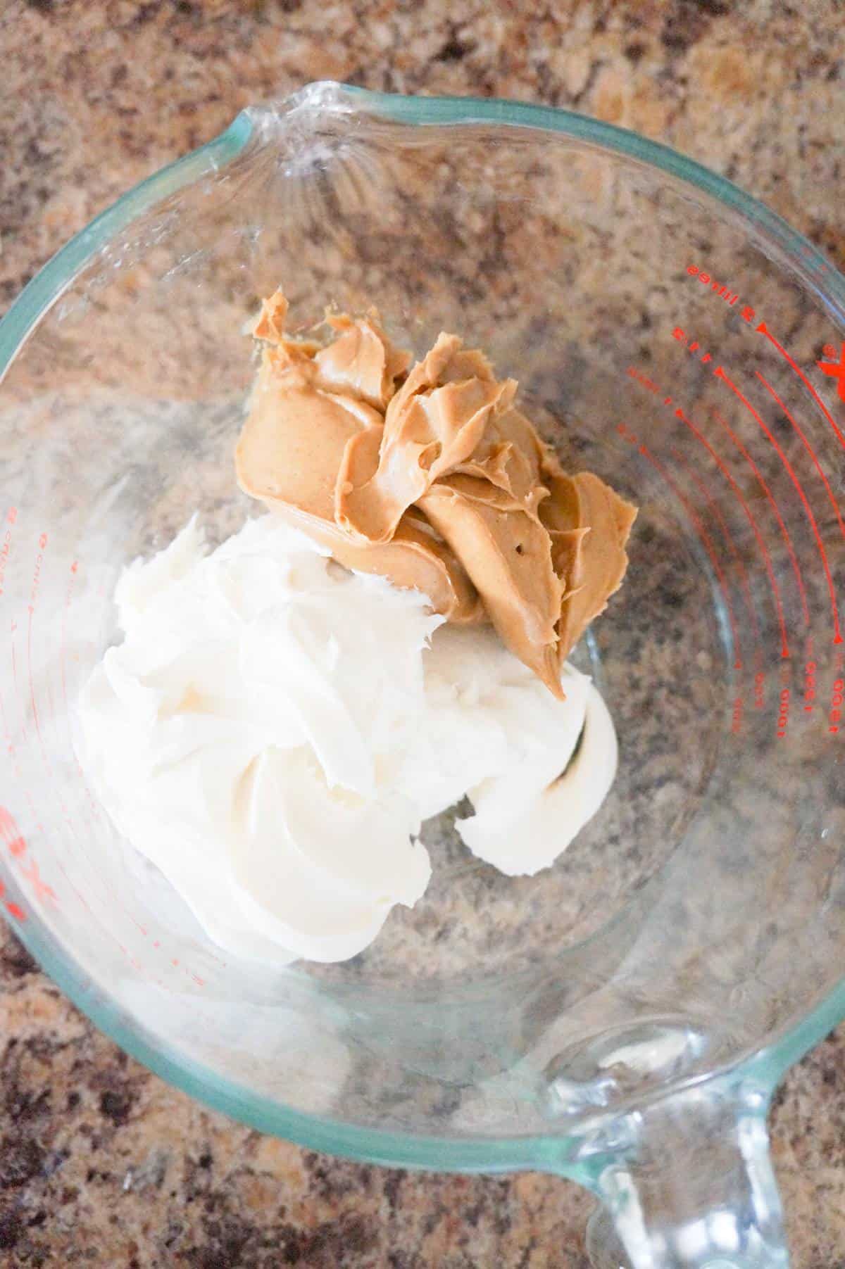 vanilla frosting and smooth peanut butter in a glass bowl