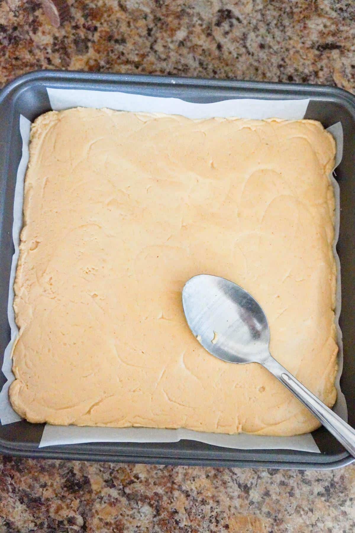 peanut butter fudge mixture smoothed out in a pan