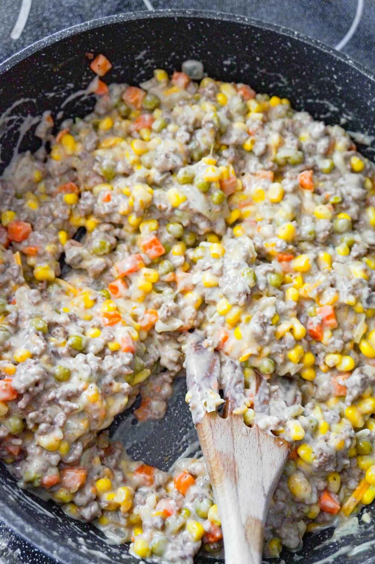 creamy ground beef and veggie mixture in a large saute pan
