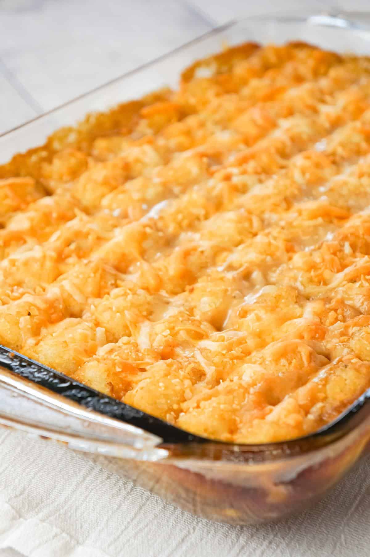 Tater Tot Hotdish is an easy ground beef casserole recipe loaded with canned veggies, cream of mushroom soup, cheddar cheese and topped with tater tots.