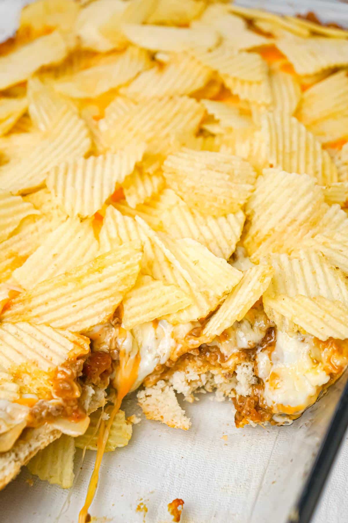 Cheeseburger Casserole with Potato Chips is an easy ground beef dinner recipe with a Bisquick base loaded with hamburger meat, diced onions, tomatoes and cheese all topped with ruffled potato chips.