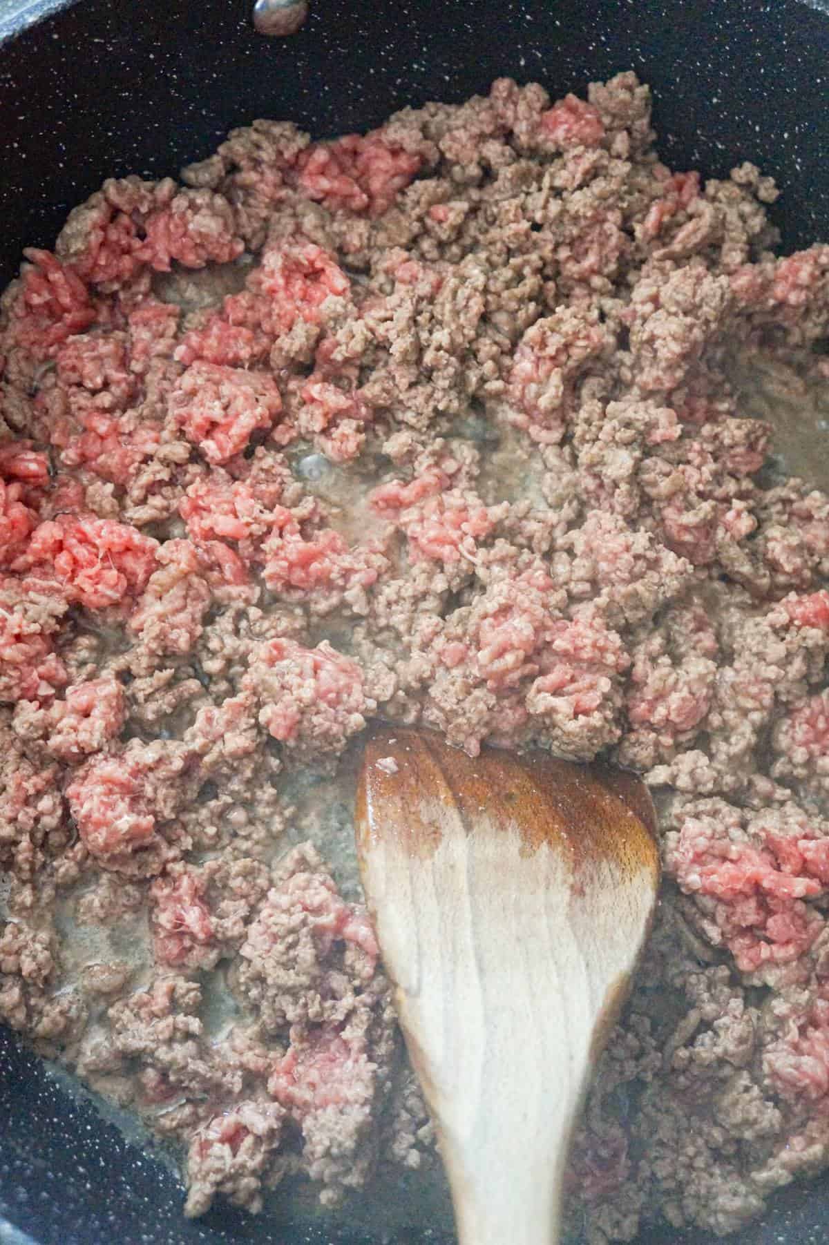 ground beef cooking in a saute pan