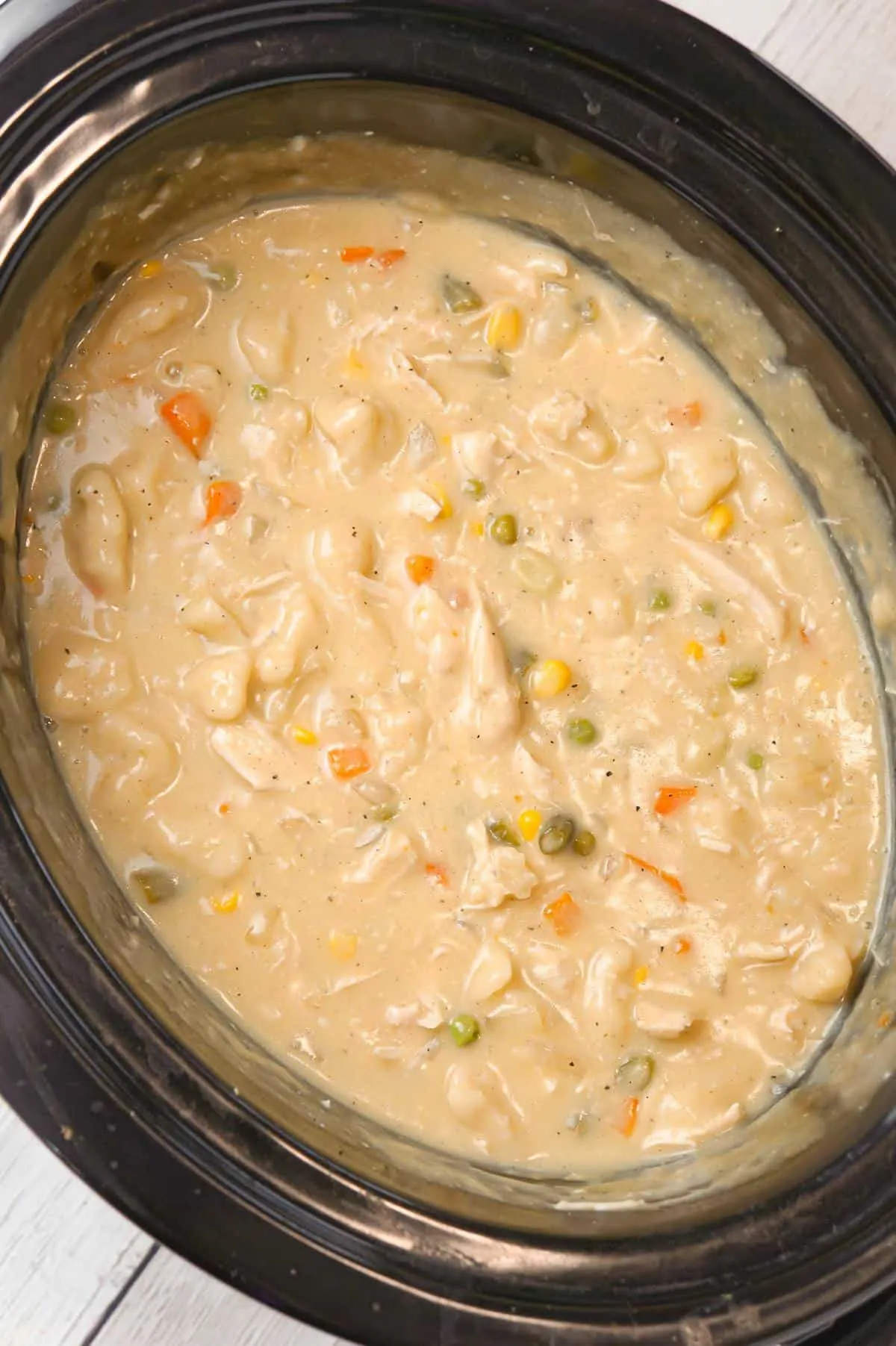 Crock Pot Chicken and Dumplings is an easy slow cooker dinner recipe loaded with chicken breast, veggies and Pillsbury biscuit dough dumplings all in a creamy sauce.