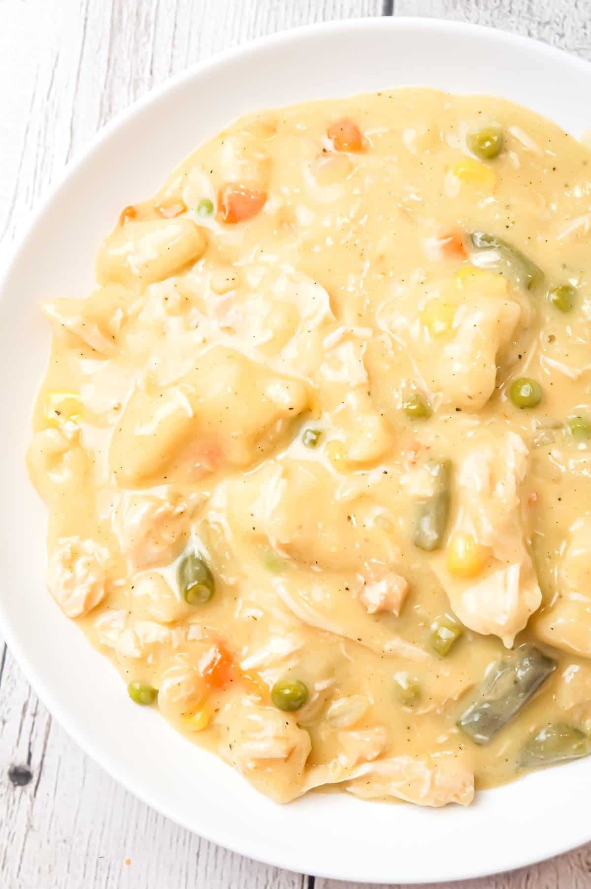 Crock Pot Chicken and Dumplings is an easy slow cooker dinner recipe loaded with chicken breast, veggies and Pillsbury biscuit dough dumplings all in a creamy sauce.