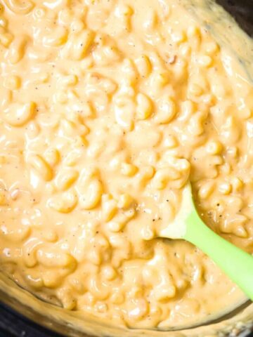 Crock Pot Mac and Cheese is an easy macaroni and cheese recipe made with condensed cheddar cheese soup, heavy cream and shredded mozzarella and cheddar cheese.