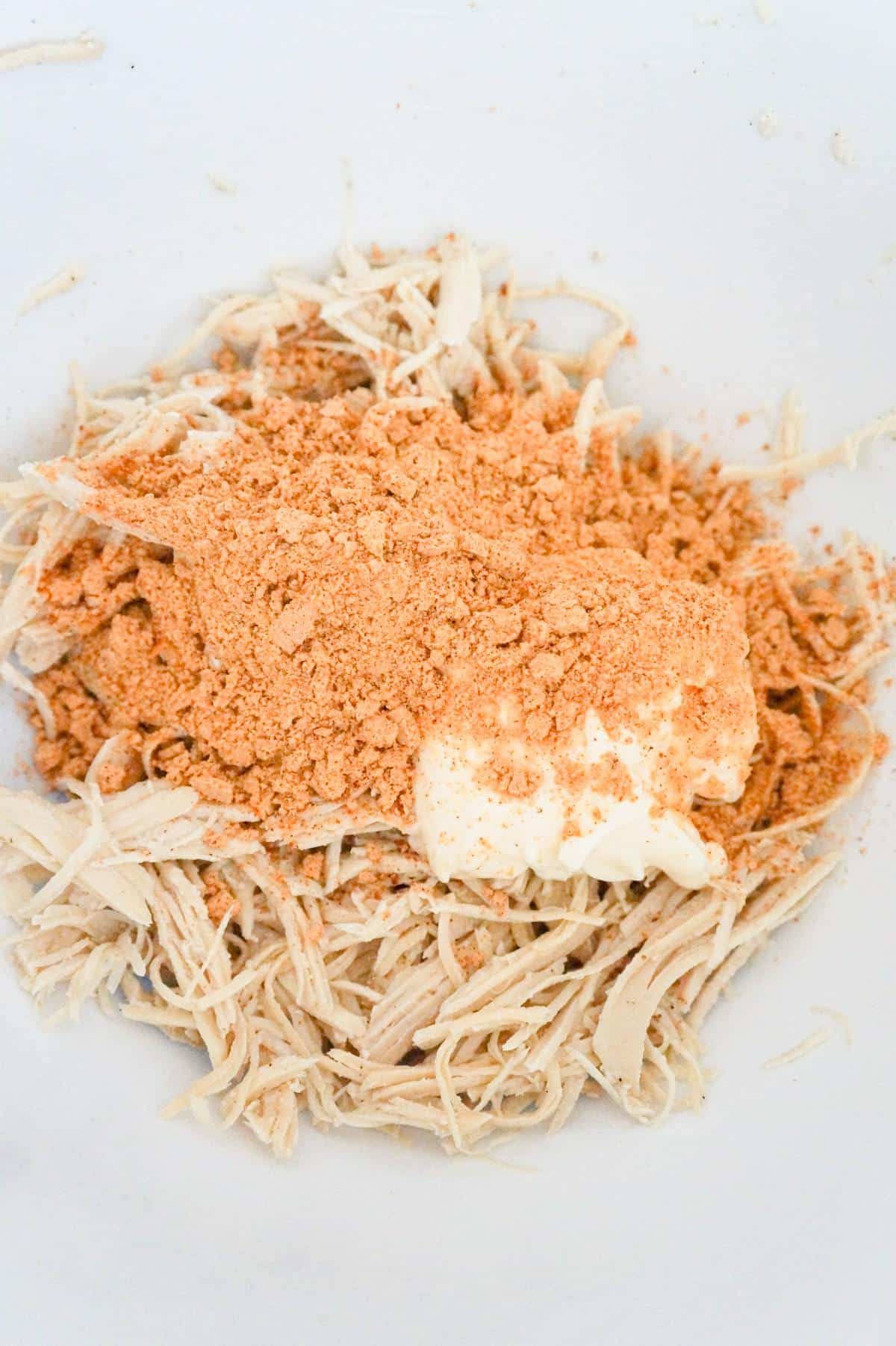 taco seasoning, mayo and shredded chicken in a mixing bowl