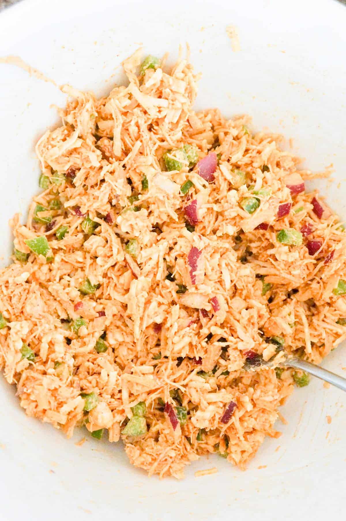 shredded chicken taco mixture in a mixing bowl
