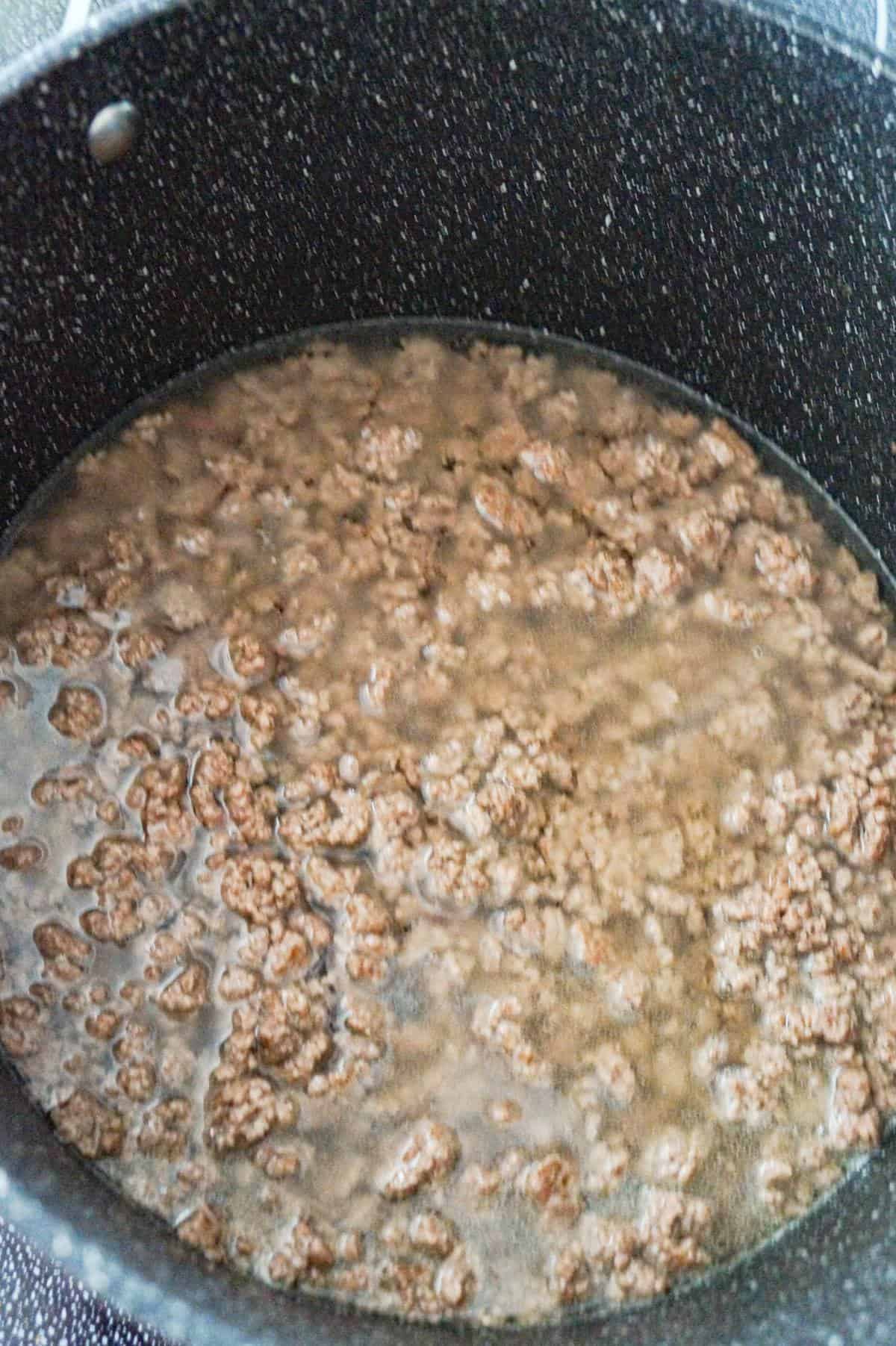 water and cooked ground beef in a large pot