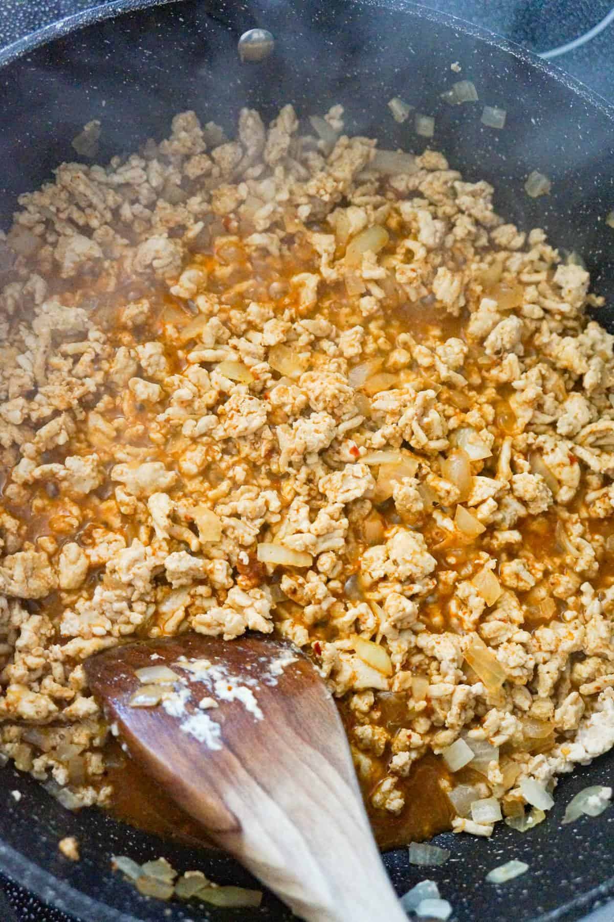 ground chicken, water and taco seasoning mixture in a saute pan