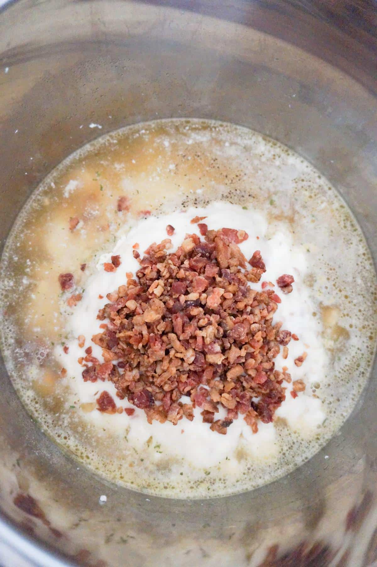 crumbled bacon on top of chicken and rice in an Instant Pot