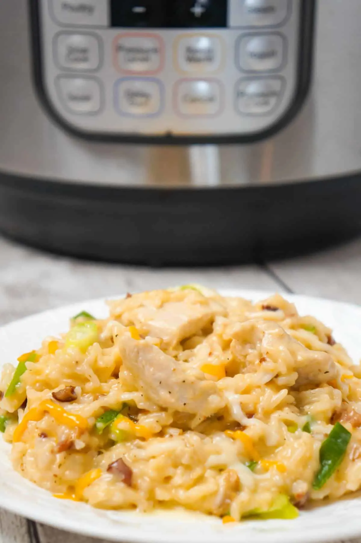 Instant Pot Cheddar Bacon Ranch Chicken and Rice is an easy pressure cooker dinner recipe loaded with chicken breast chunks, crumbled bacon and shredded cheddar cheese.