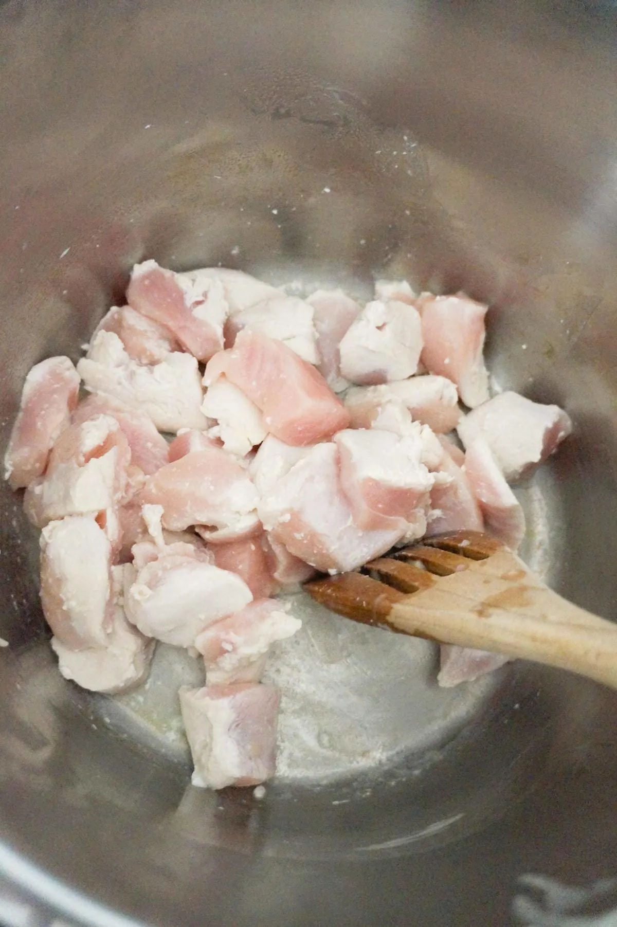 chicken breast chunks being stirred in an Instant Pot