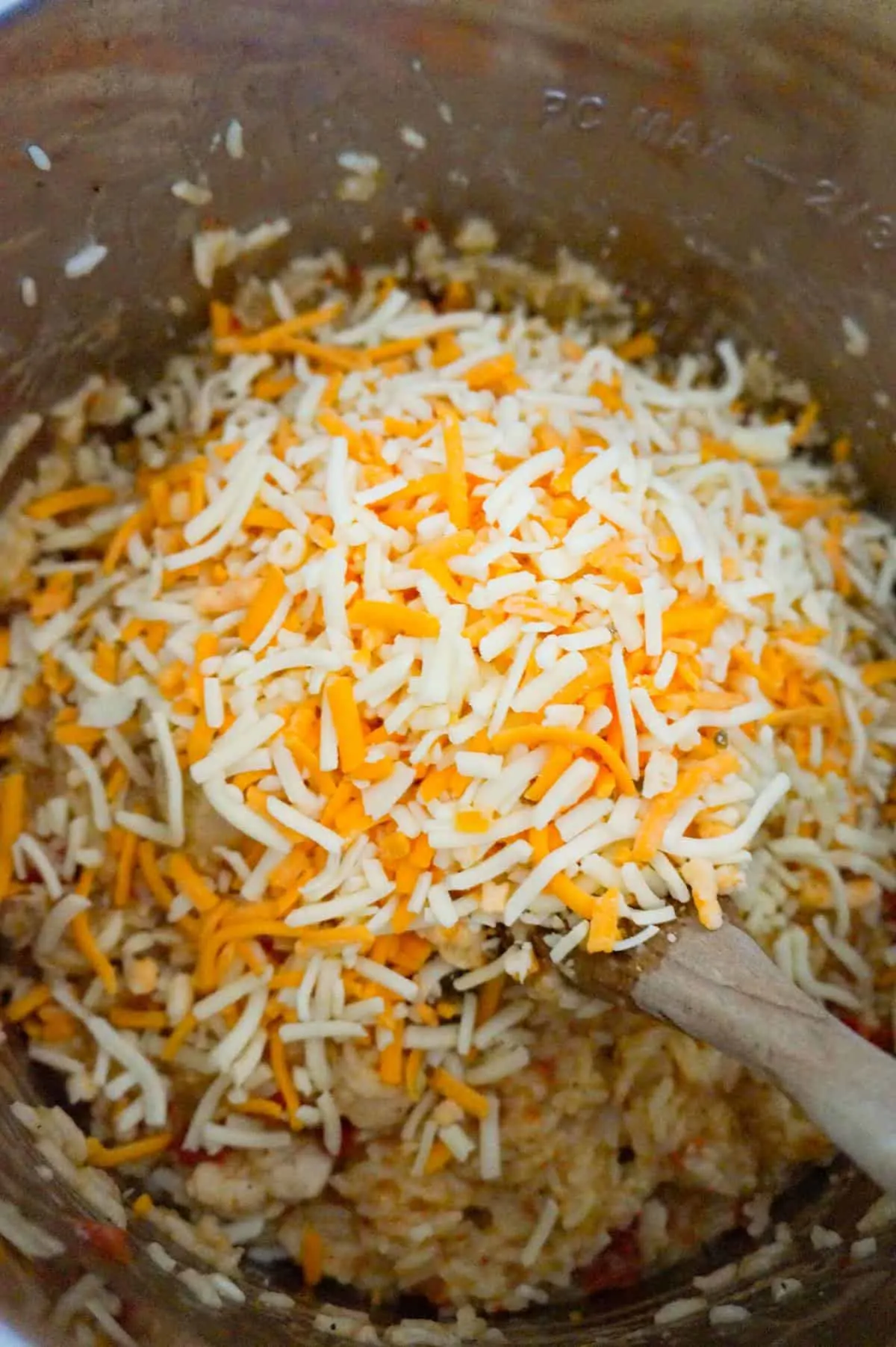 shredded cheesy on top of chicken and rice in an Instant Pot