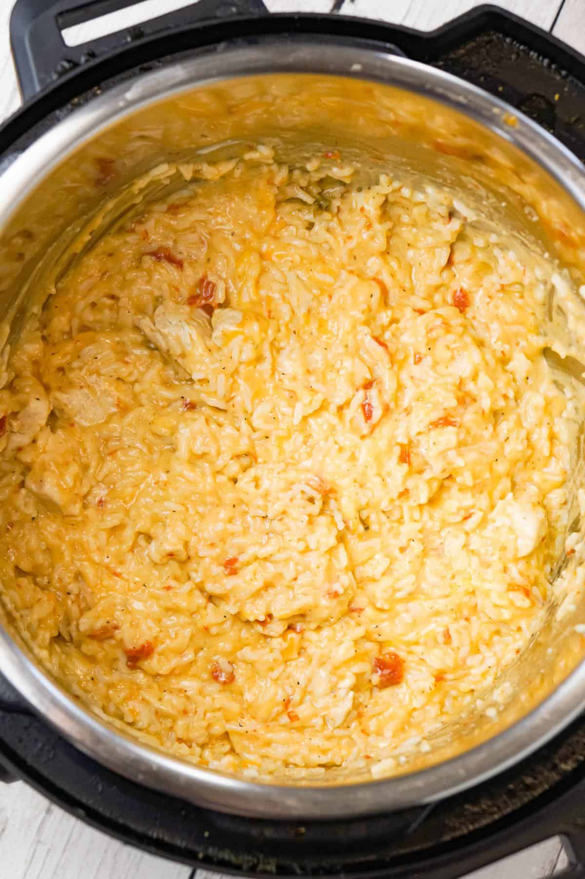 Instant Pot Cheesy Chicken and Rice is an easy pressure cooker dinner recipe made with long grain white rice and loaded with chunks of boneless, skinless chicken breasts and shredded cheese.