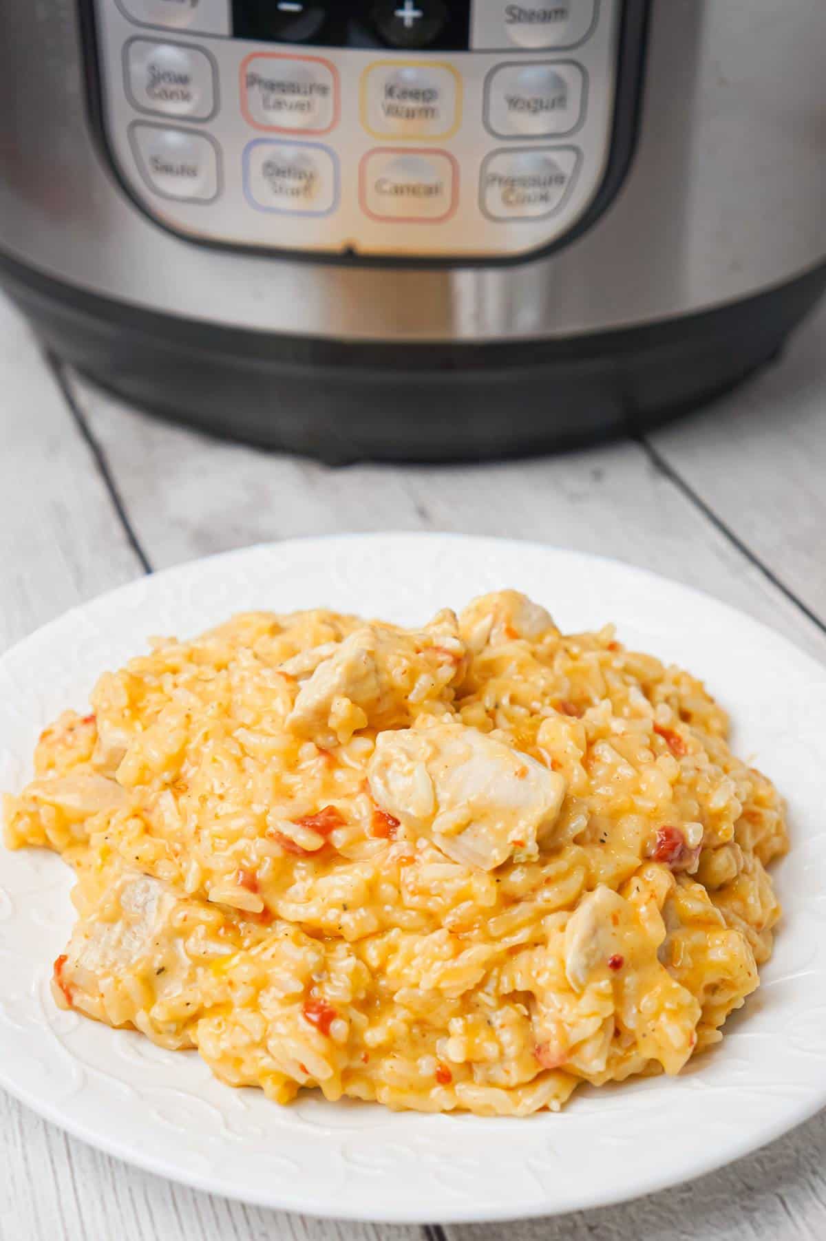 Instant Pot Cheesy Chicken and Rice is an easy pressure cooker dinner recipe made with long grain white rice and loaded with chunks of boneless, skinless chicken breasts and shredded cheese.