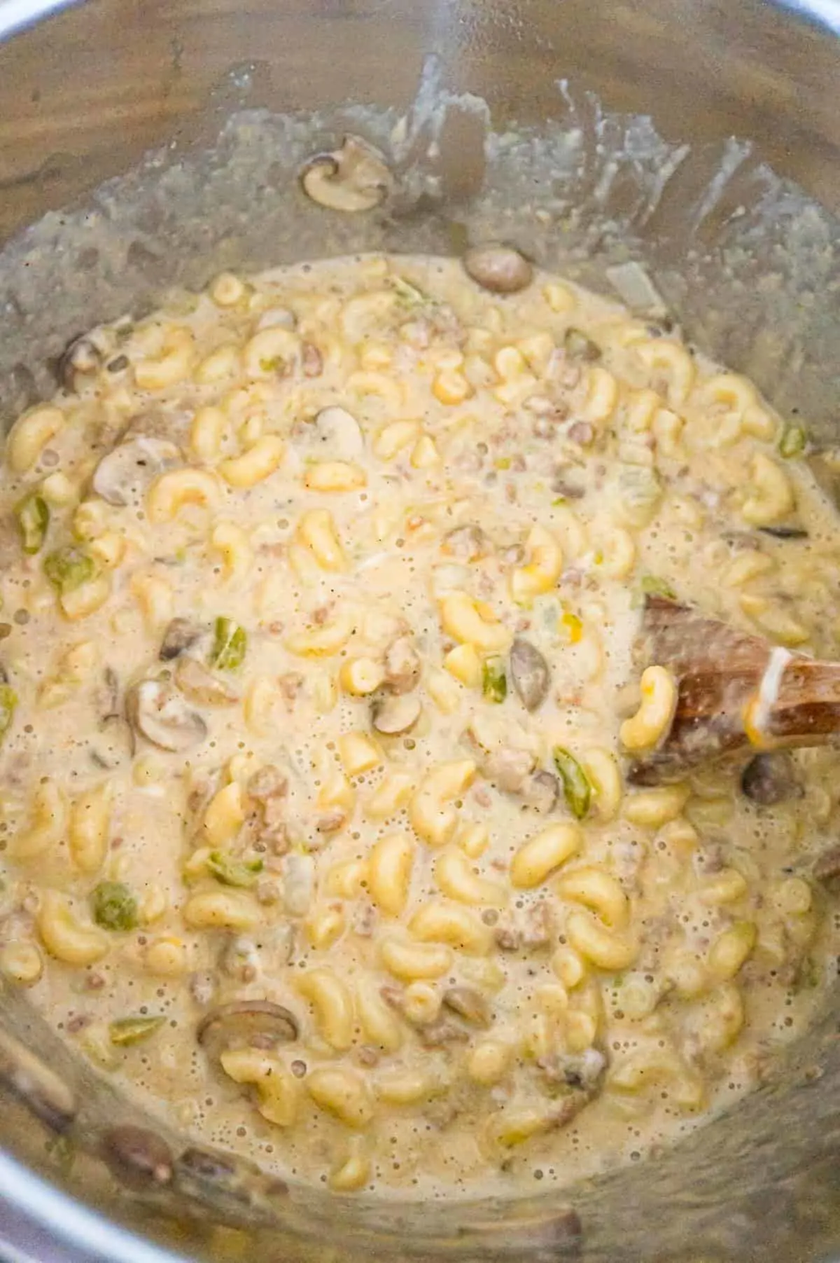 Instant Pot Philly Cheese Steak Pasta is a hearty pressure cooker macaroni recipe loaded with ground beef, green peppers, onions, mushrooms and cheese.