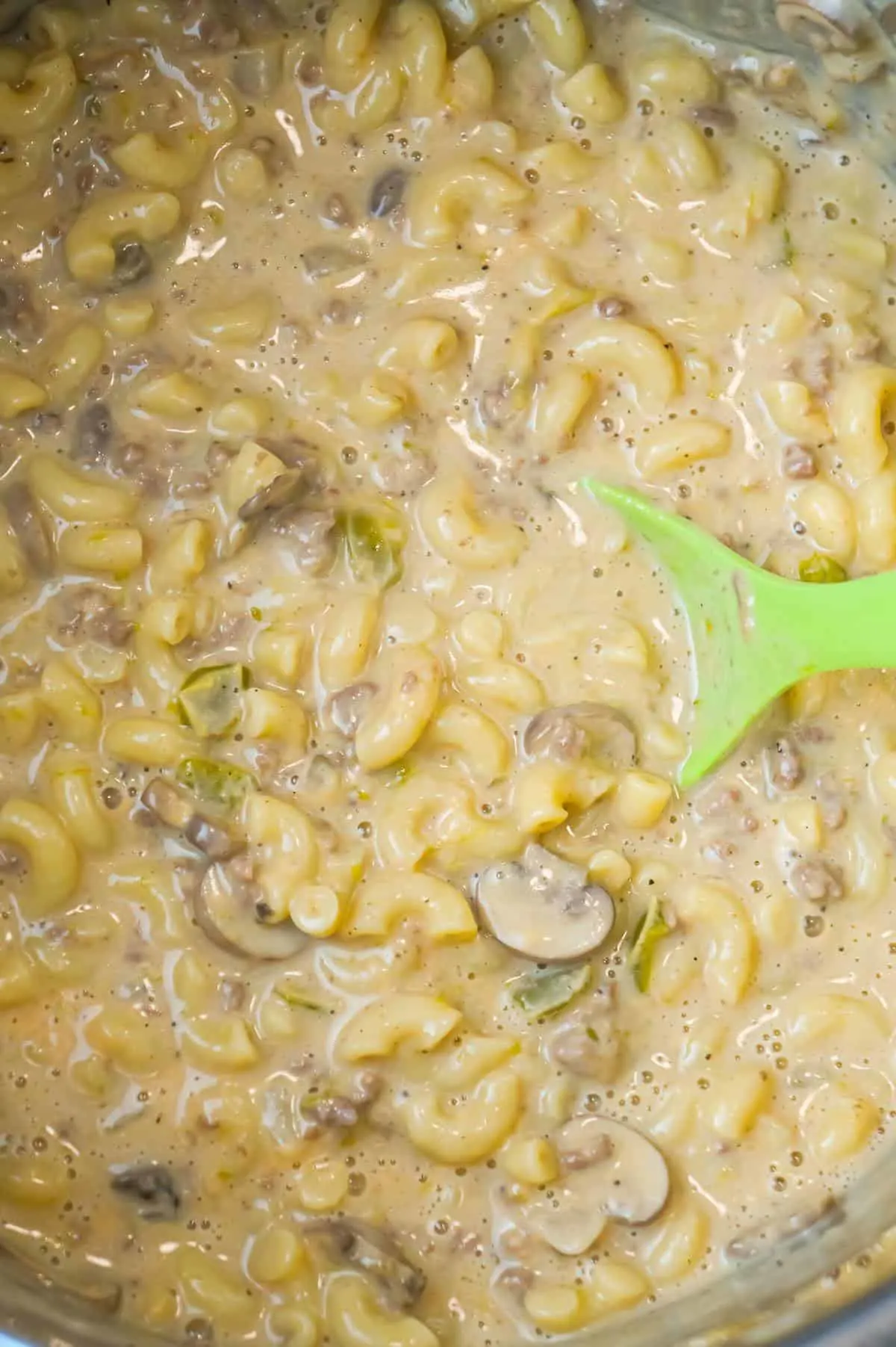 Instant Pot Philly Cheese Steak Pasta is a hearty pressure cooker macaroni recipe loaded with ground beef, green peppers, onions, mushrooms and cheese.