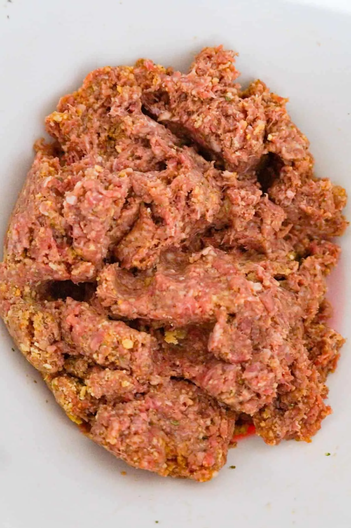 ground beef meatloaf mixture in a mixing bowl