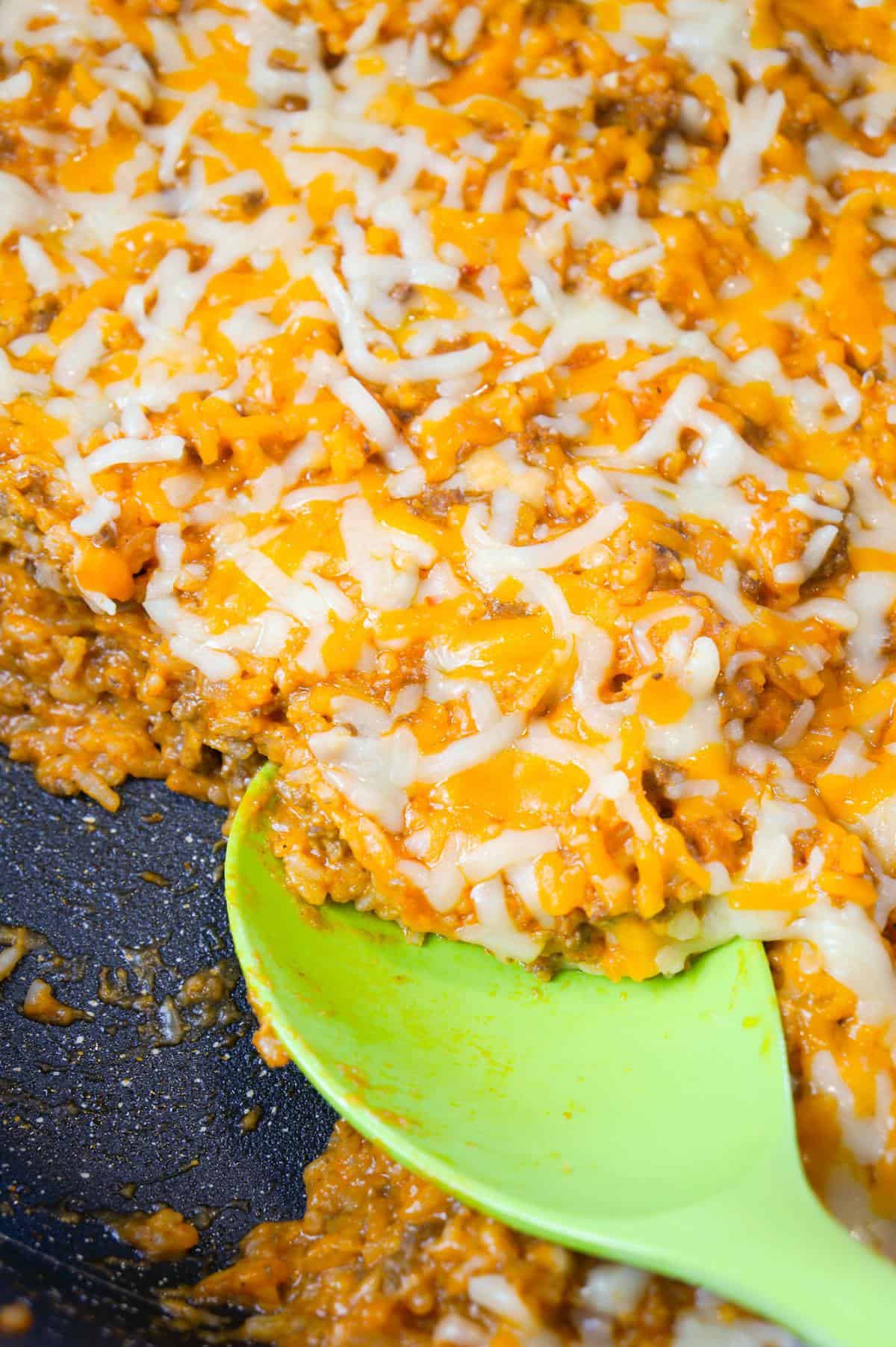 One Pot Sloppy Joe Ground Beef and Rice is an easy stove top dinner recipe made with ground beef and minute rice all tossed in sloppy joe sauce and loaded with shredded mozzarella and cheddar cheese.