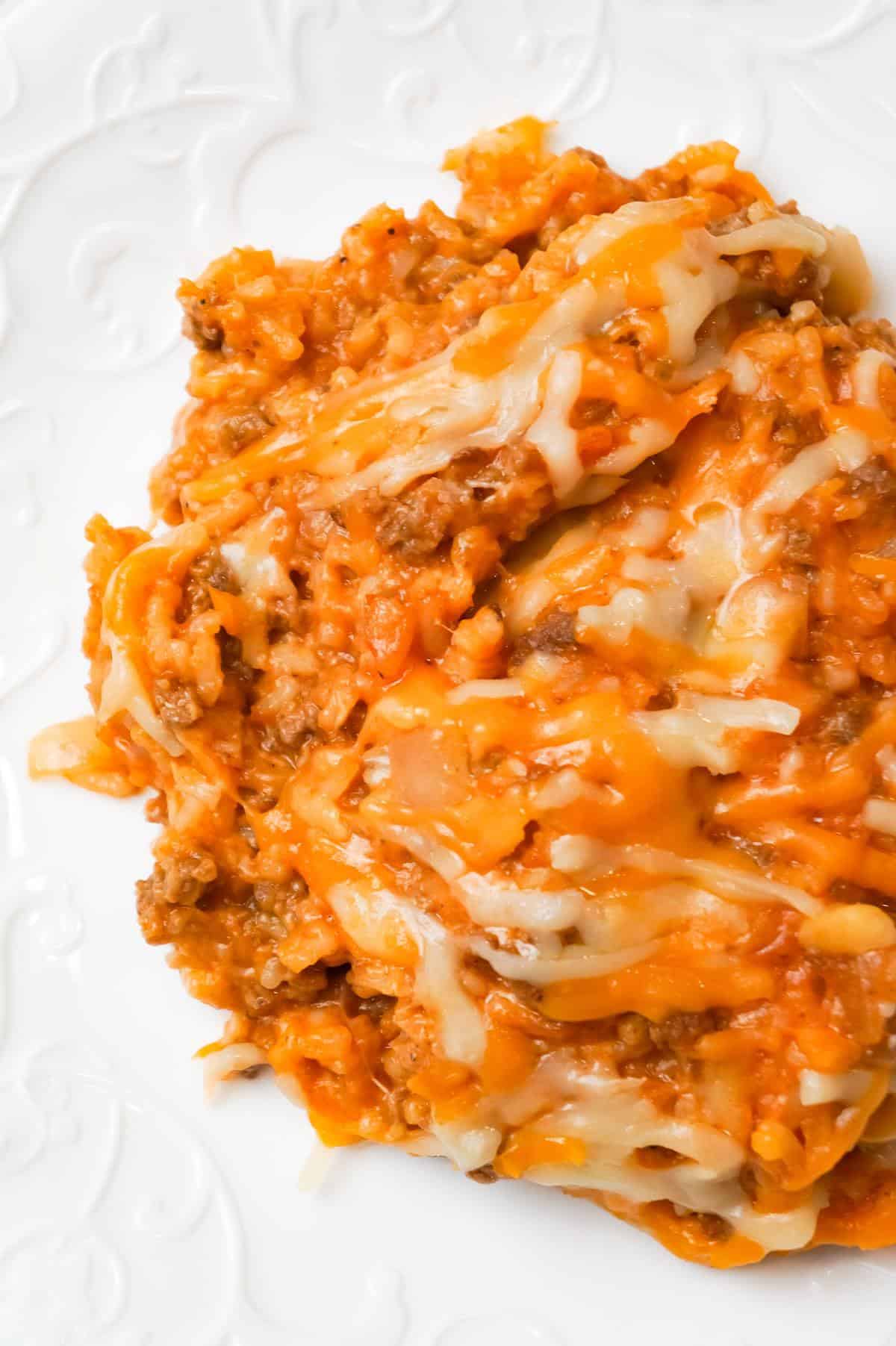 One Pot Sloppy Joe Ground Beef and Rice is an easy stove top dinner recipe made with ground beef and minute rice all tossed in sloppy joe sauce and loaded with shredded mozzarella and cheddar cheese.