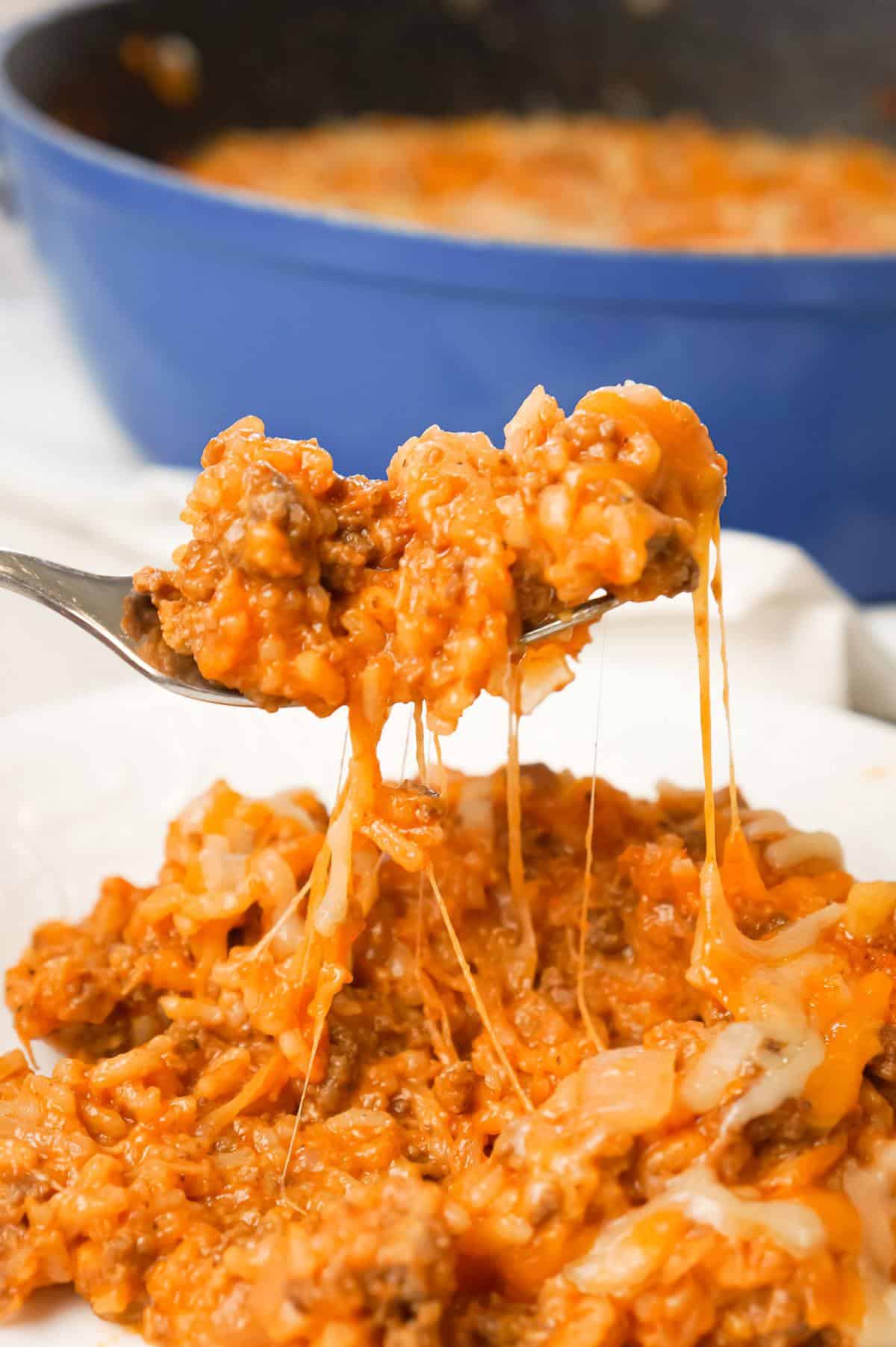 One Pot Sloppy Joe Ground Beef and Rice is an easy stove top dinner recipe made with ground beef and minute rice all tossed in sloppy joe sauce and loaded with shredded mozzarella and cheddar cheese.