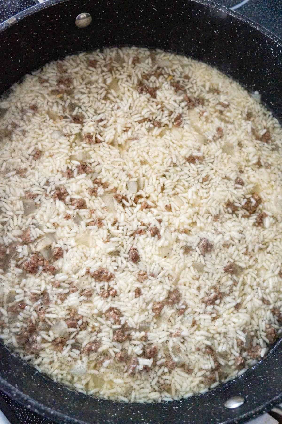 chicken broth, minute rice and ground beef in a saute pan