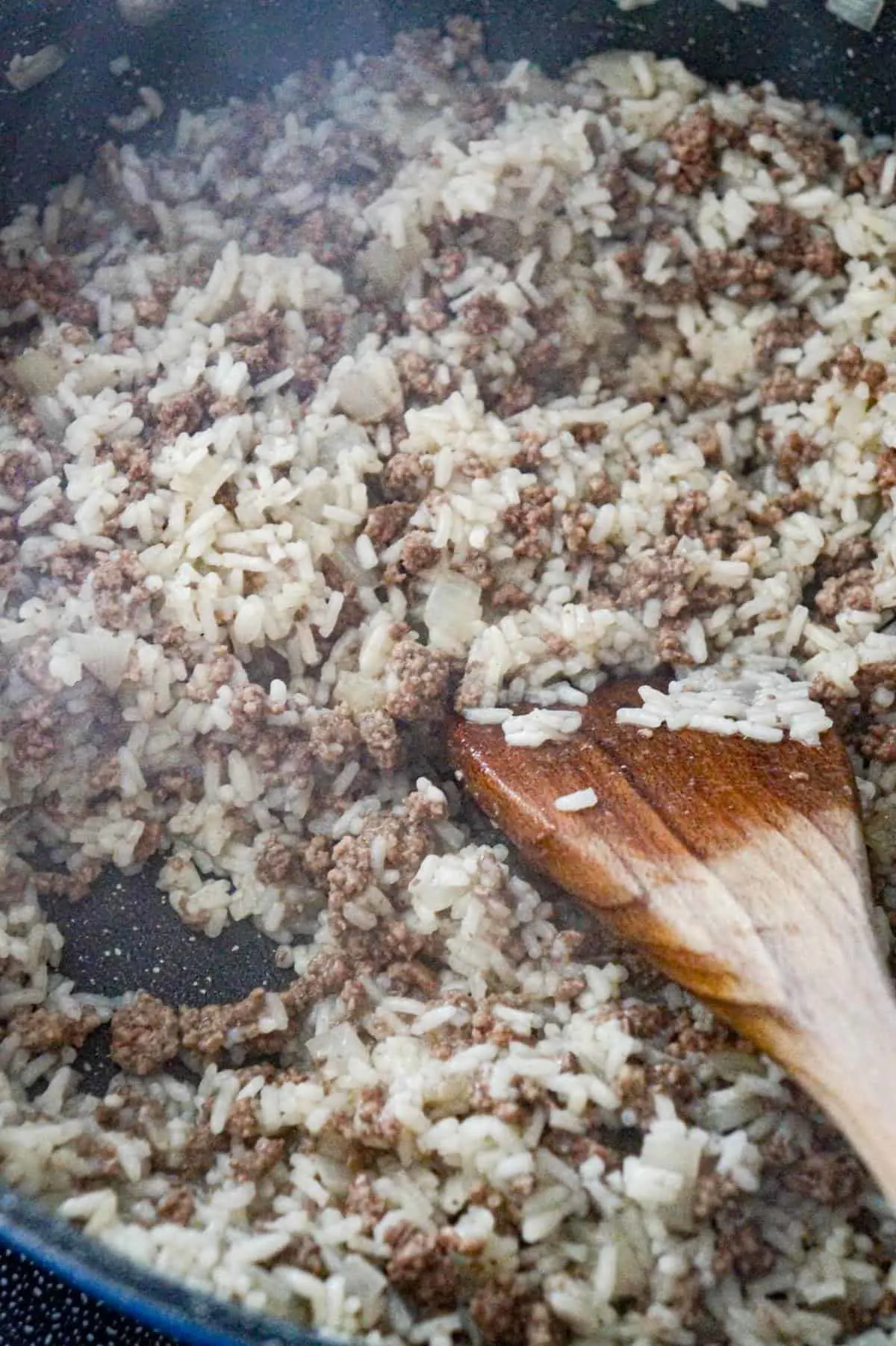 cooked ground beef and rice in a saute pan