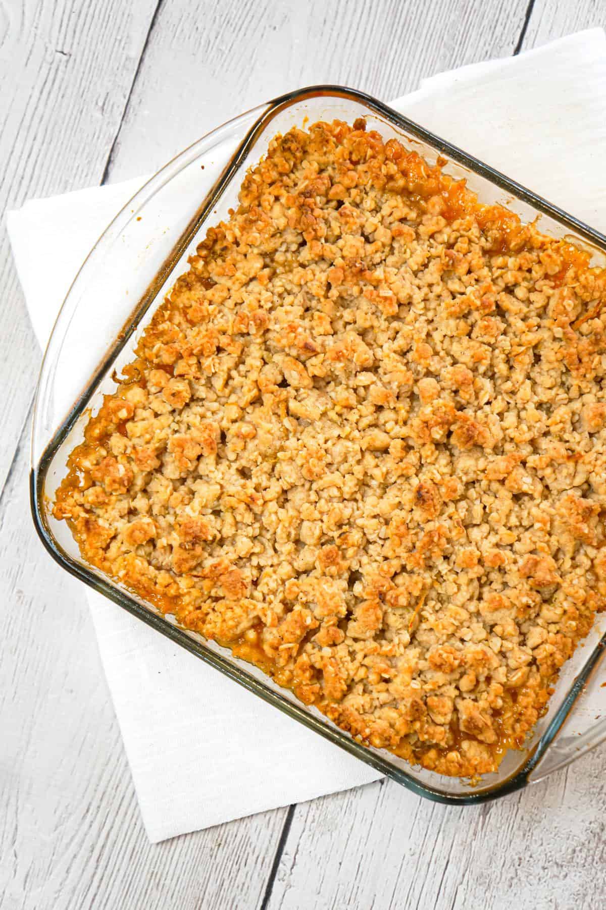 Peach Crumble is a delicious dessert recipe made with canned peaches and topped with a crunchy crumble topping with hints of cinnamon and citrus.