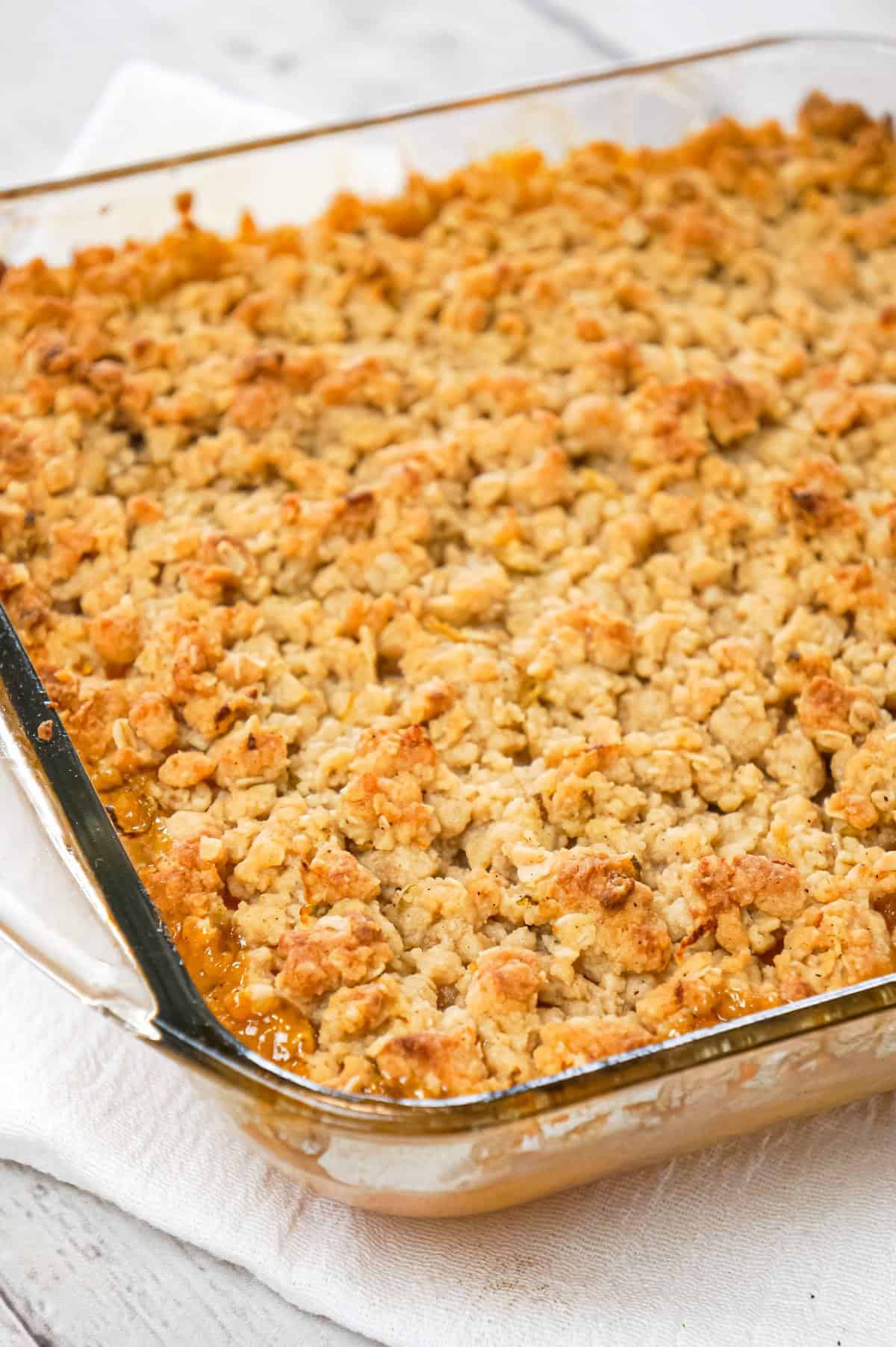 Peach Crumble is a delicious dessert recipe made with canned peaches and topped with a crunchy crumble topping with hints of cinnamon and citrus.