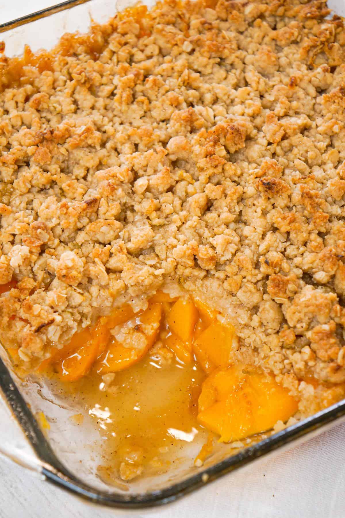 Peach Crumble is a delicious dessert recipe made with canned peaches and topped with a crunchy crumble topping with hints of cinnamon and citrus.