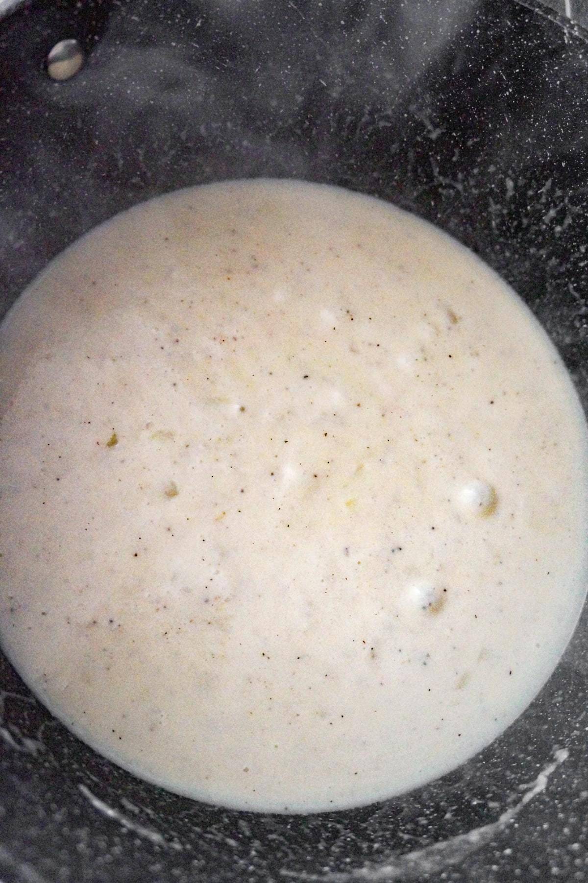 creamy onion sauce just starting to boil
