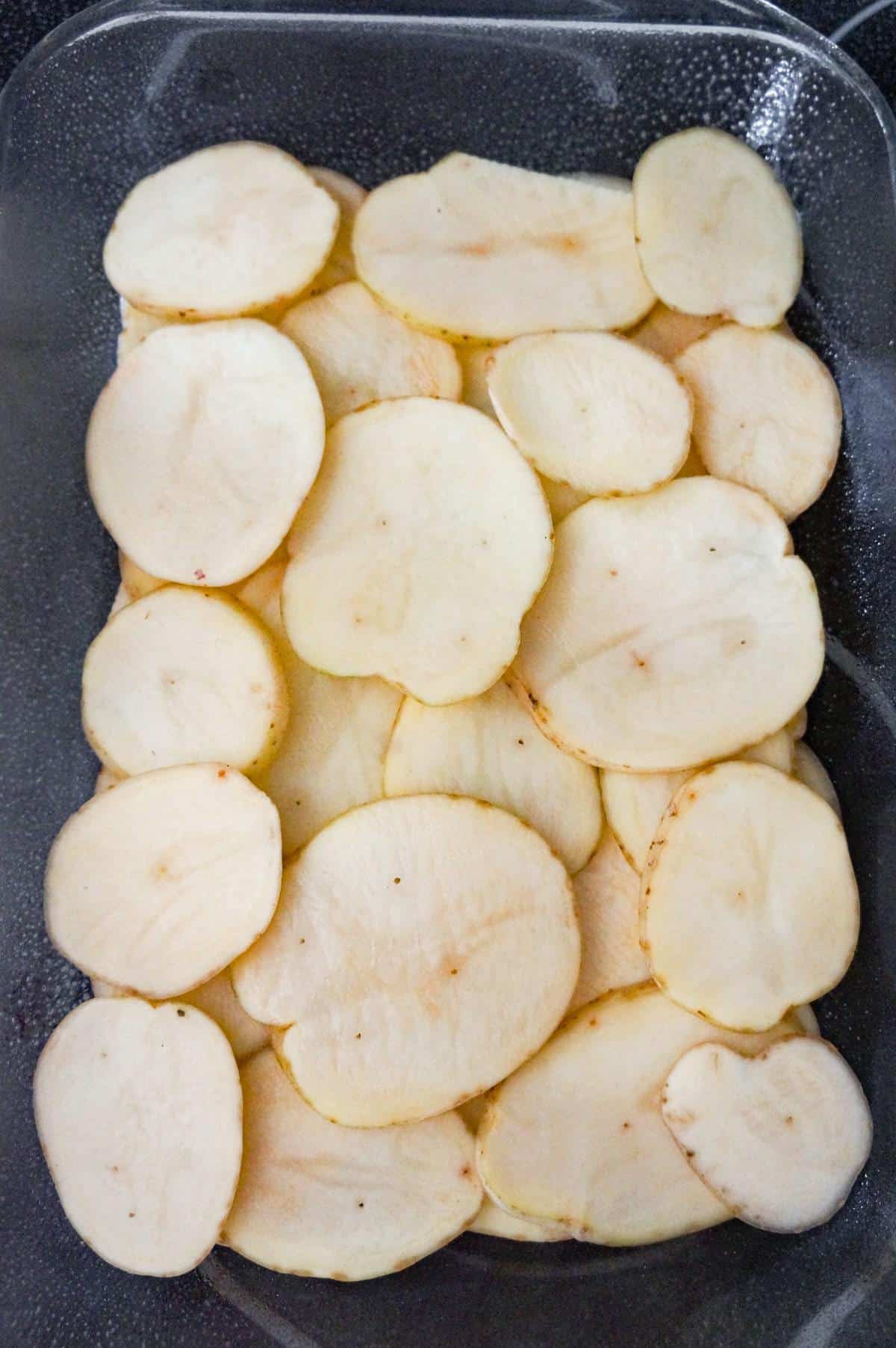 sliced potatoes in a 9 x 13 inch baking dish