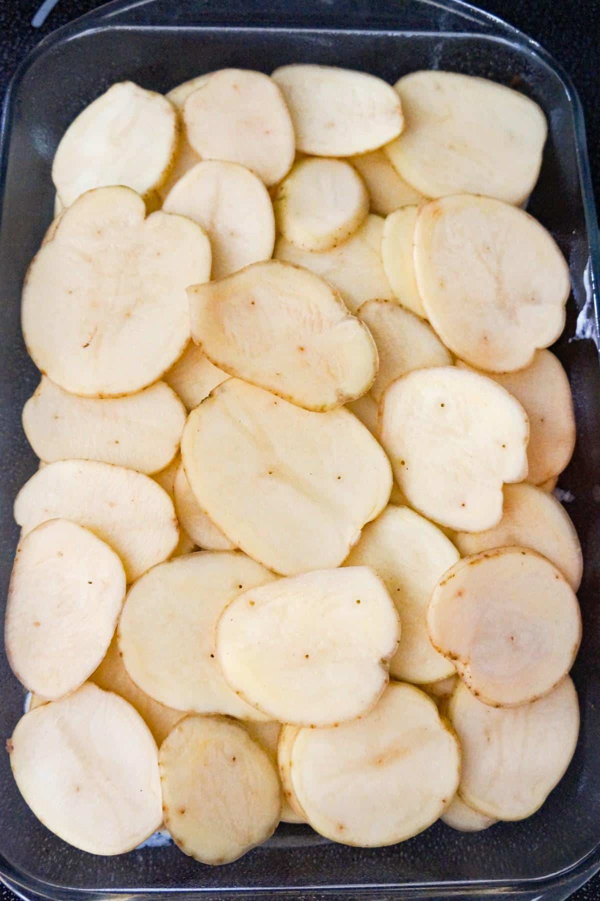 sliced potatoes in a baking dish