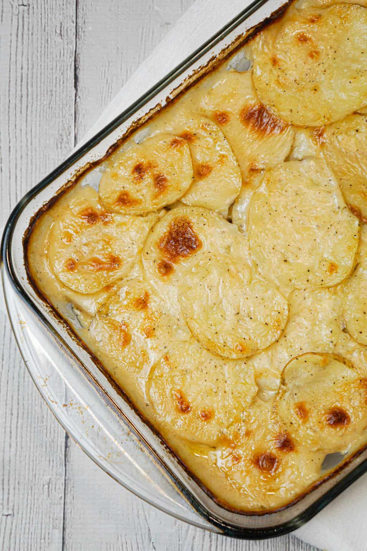 Scalloped Potatoes are a delicious side dish recipe made with thinly sliced potatoes layered with a creamy onion sauce and baked in the oven.