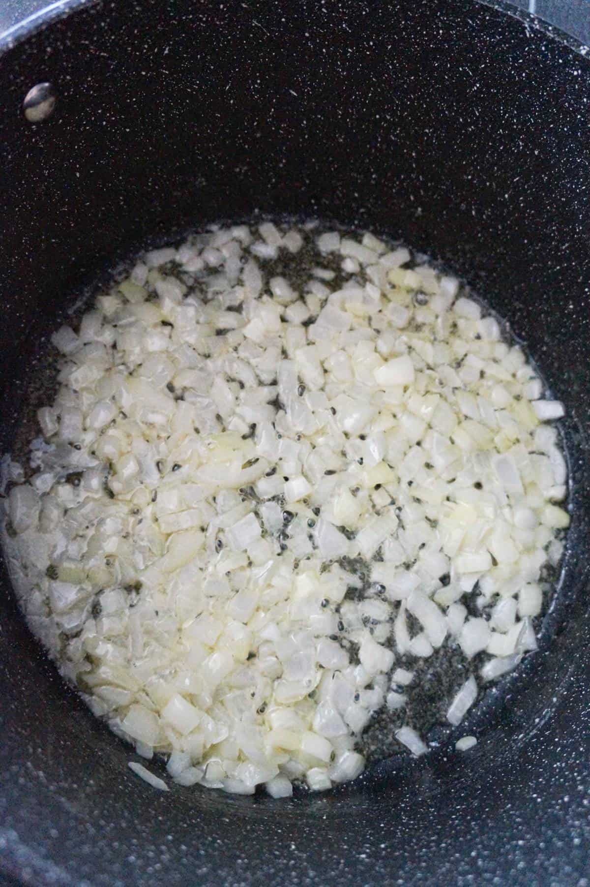 diced onions cooking in butter in a large pot