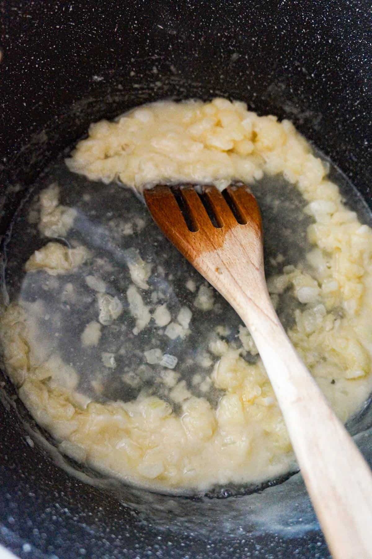 broth added to flour and onion mixture in a large pot