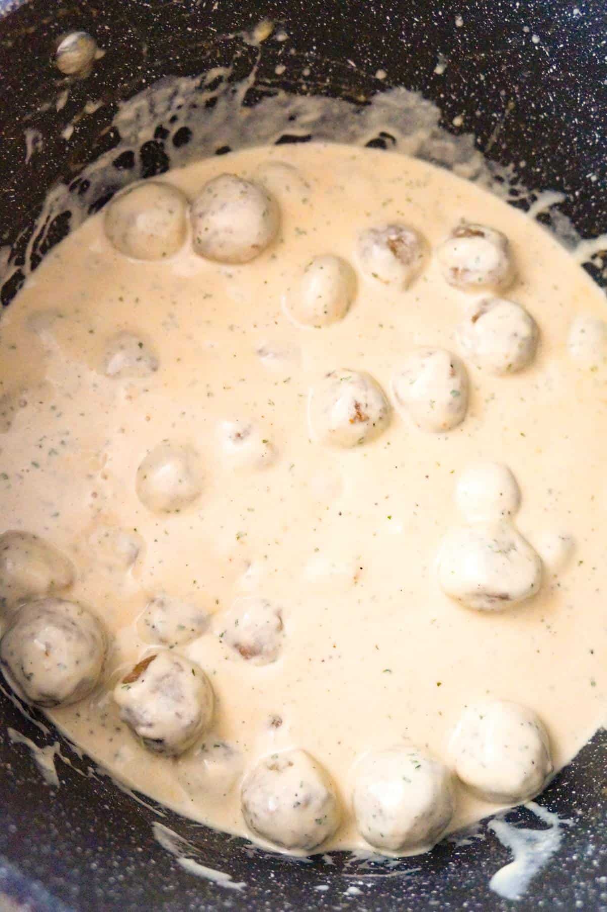 Swedish meatballs and cream sauce in a large pot