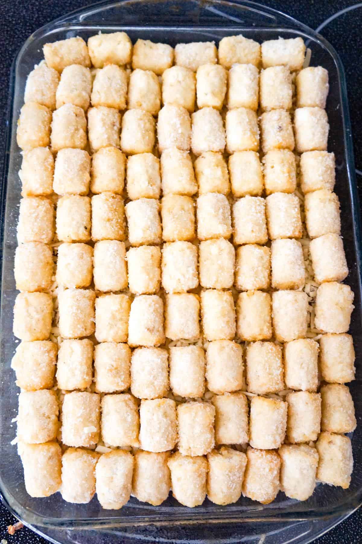 frozen tater tots on top of Swedish meatball casserole before baking
