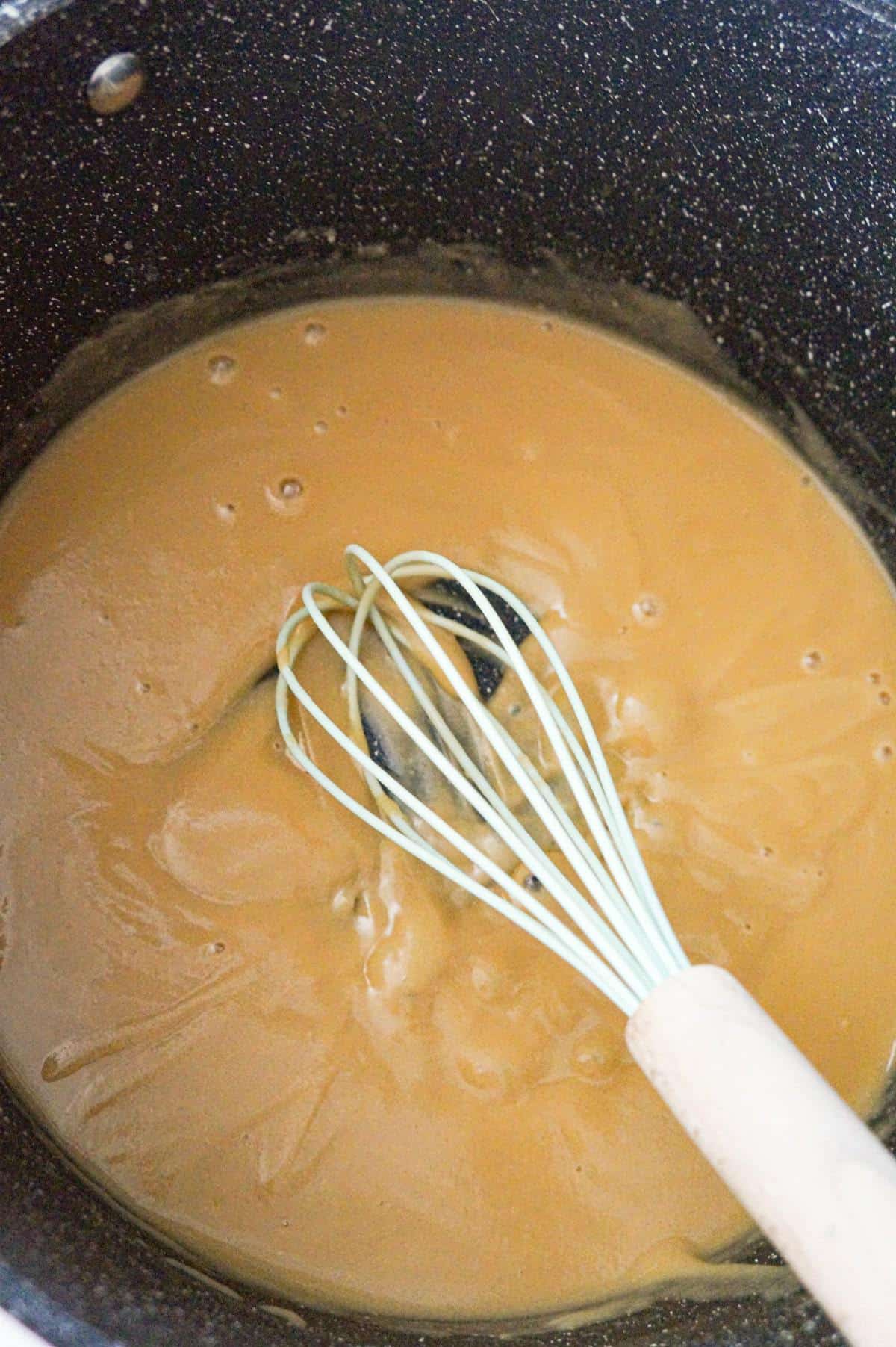 beef broth whisked into flour and butter mixture