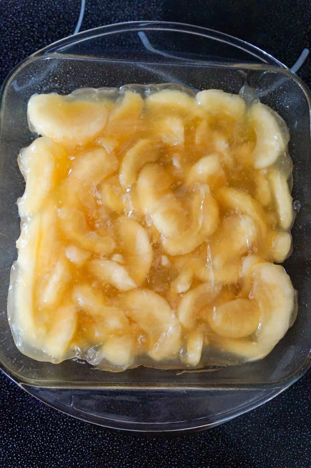 apple pie filling in a glass baking dish