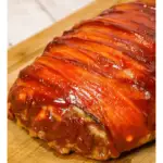 Bacon Wrapped Meatloaf is a delicious ground beef meatloaf with a ketchup glaze wrapped in strips of bacon.